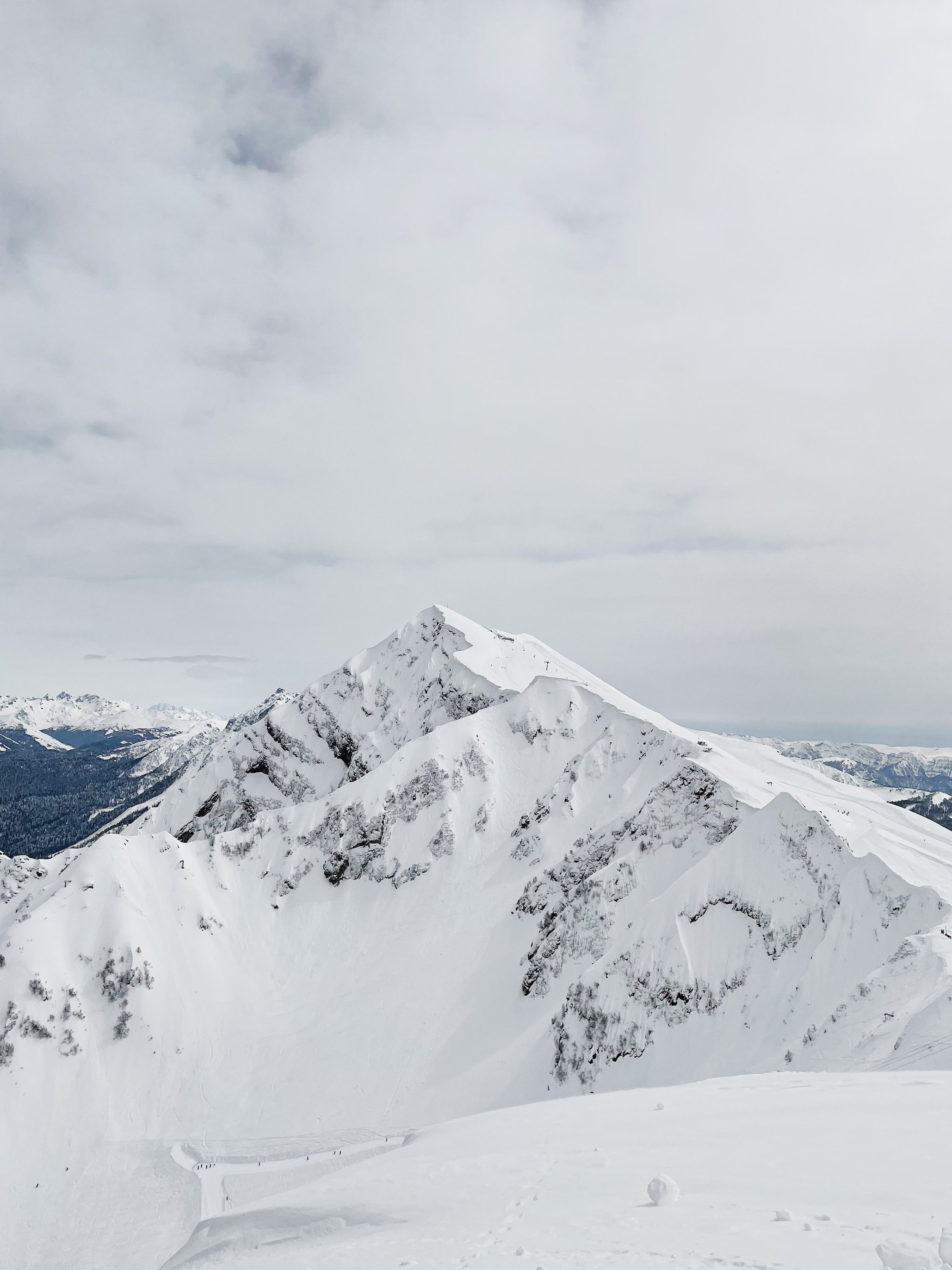 Snow Covered Mountain Under Cloudy Sky